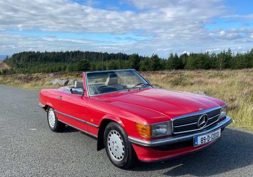 Red Mercedes-Benz 300SL Cabriolet parked on a road