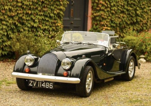 Morgan 4/4 in Connaught Green parked in a garden