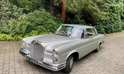 Silver Mercedes 220SEB Coupe parked on a stone pathway