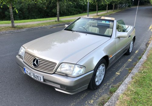 Silver convertible Mercedes parked on a street